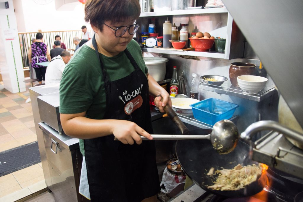 Ms Debbie Yam preparing food at the hawker stall