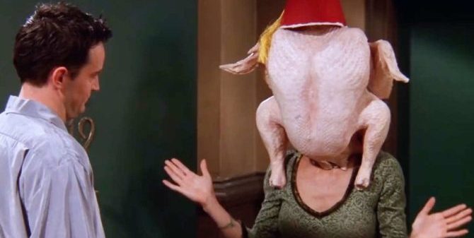 A photo of two characters from the hit TV show, Friends. Character Monica Geller has a turkey over her head in this episode where her co-star Ross Geller gets high during Thanksgiving