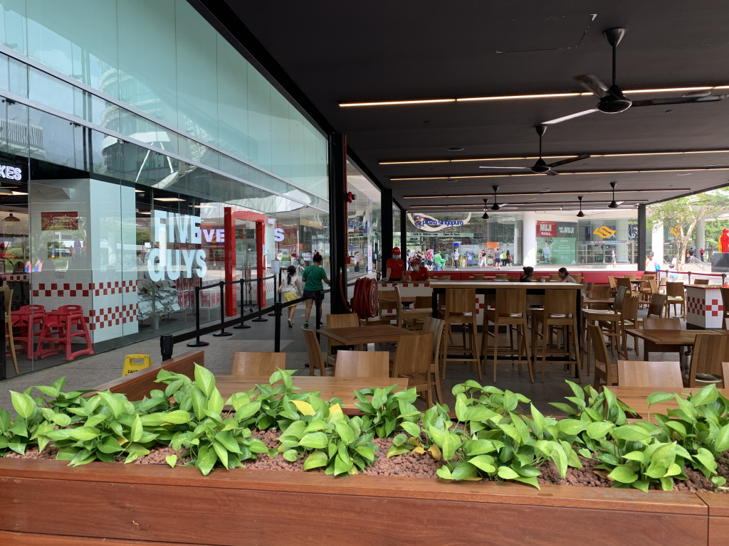 Empty seats at Five Guy's outdoor seating area at the Plaza Singapura outlet