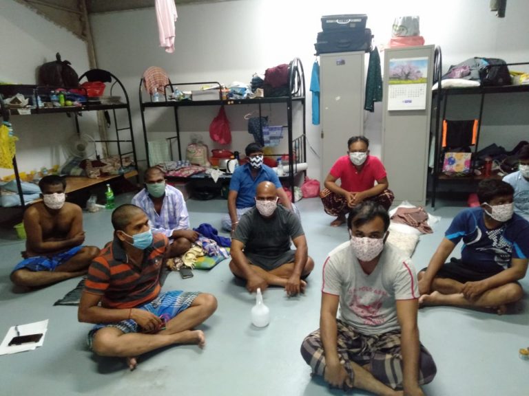 A photo of the migrant workers at Tekong Polder wearing the masks that Mr Bernard Ng had sewn for them