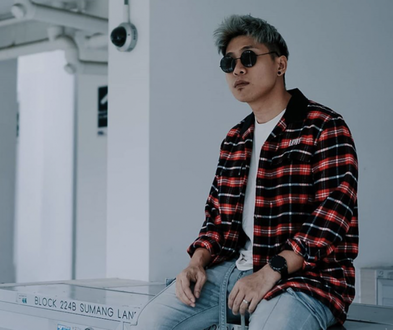 Johnathan Chua, host of the Youtube show Real Talk and owner of Grvty Media, sitting on top of mail boxes at a HDB void deck.