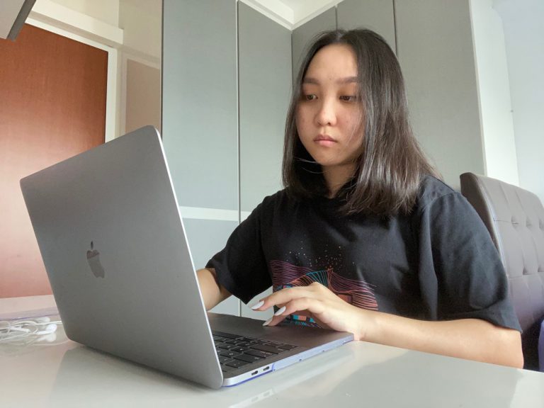 A photo of Niki Chin, a Ngee Ann Polytechnic Student doing work on her laptop