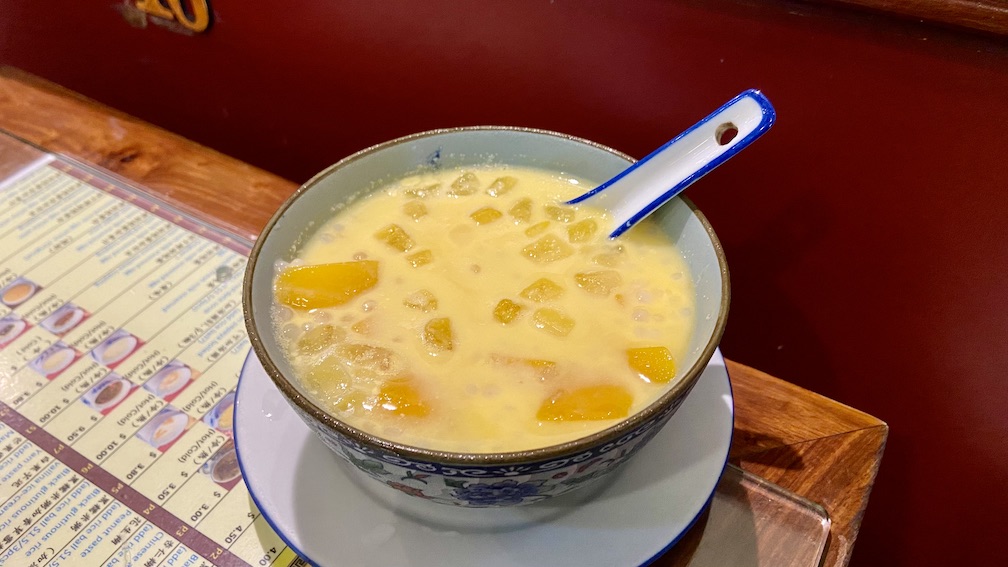 A bowl full of Mango Sago dessert
