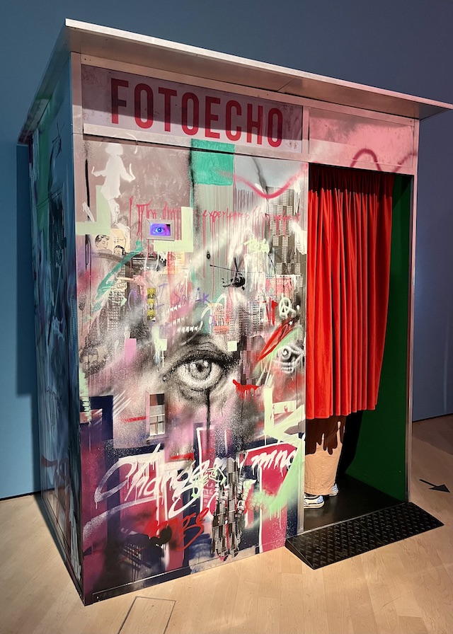 A photobooth decorated with graffiti 