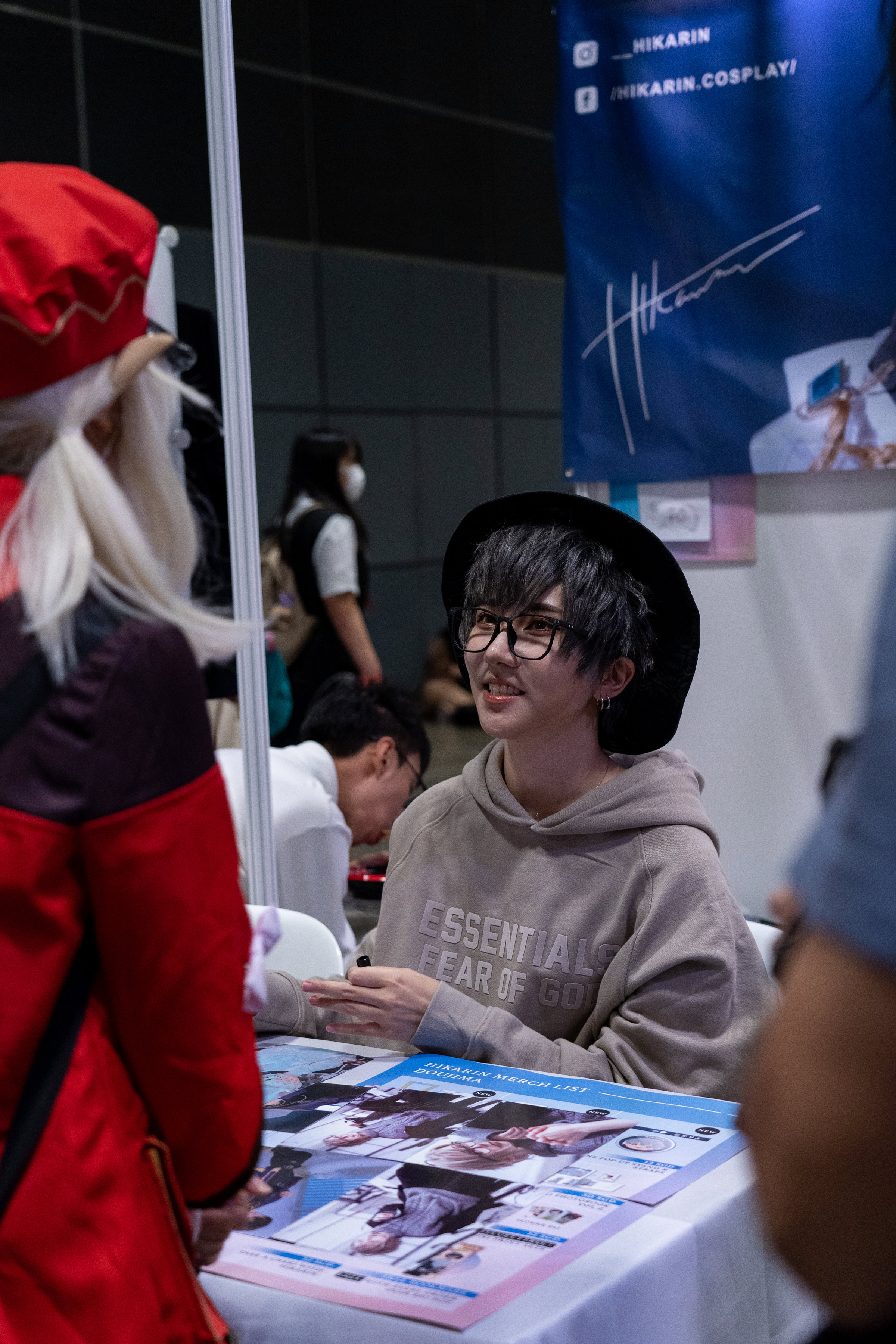 Famous cosplayer, Hikarin, chatting with a fan at her meet-and-greet booth.