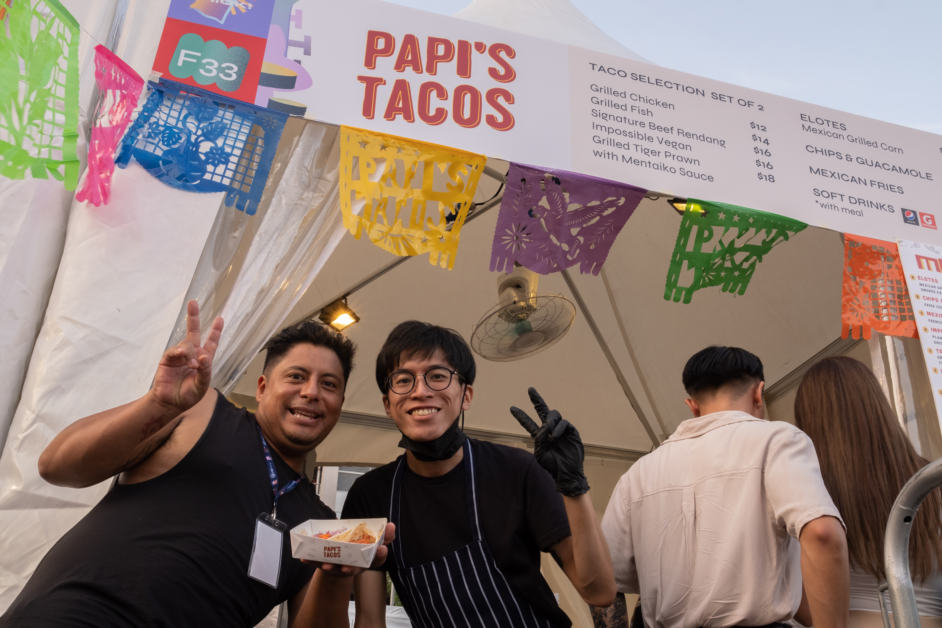 Head chef and owner of Papi’s Taco, Mauricio Espinoza (left) posing with one of his chefs.