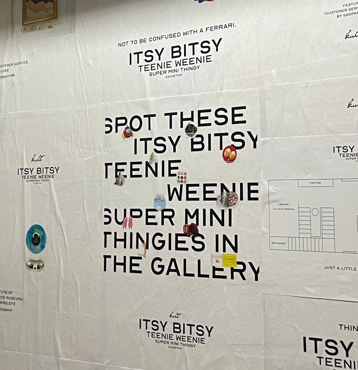 This photo shows a poster located at the entrance of the Itsy Bitsy Exhibition. The text says Spot These Itsy Bitsy Teeny Weenie Super Mini Thingies in the Gallery.